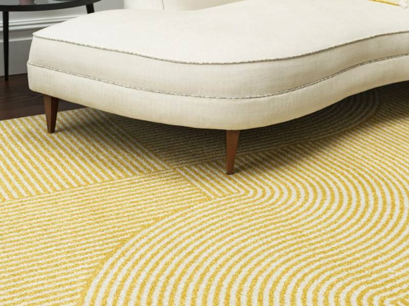 Muse yellow geometric rug in a living room