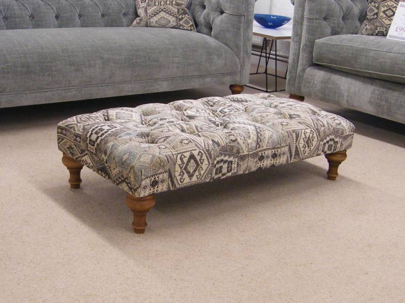 A patterned low profile stool in the showroom for sale